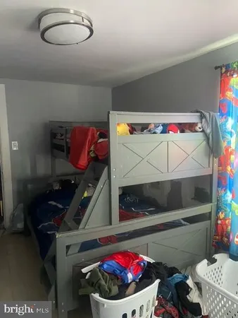 a bedroom with a bed and a potted plant