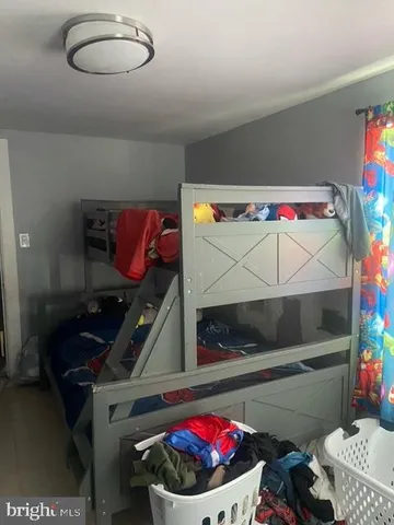 a bedroom with a bed and a potted plant