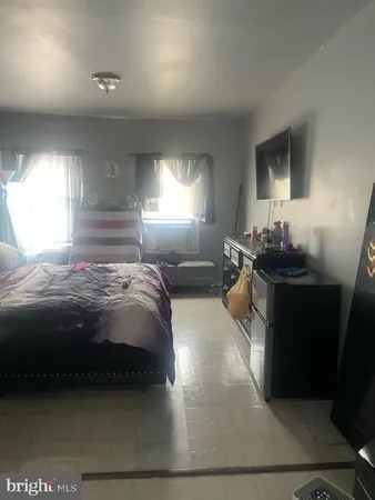 a bedroom with a bed and window