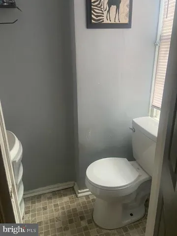 a white toilet sitting next to a shower