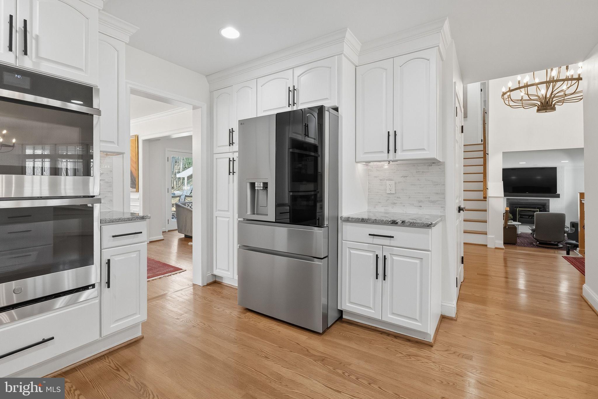 11728 Stuart Mill Road Oakton, VA 22124 - Photo 28 of 88 a kitchen with stainless steel appliances a refrigerator and a stove top oven