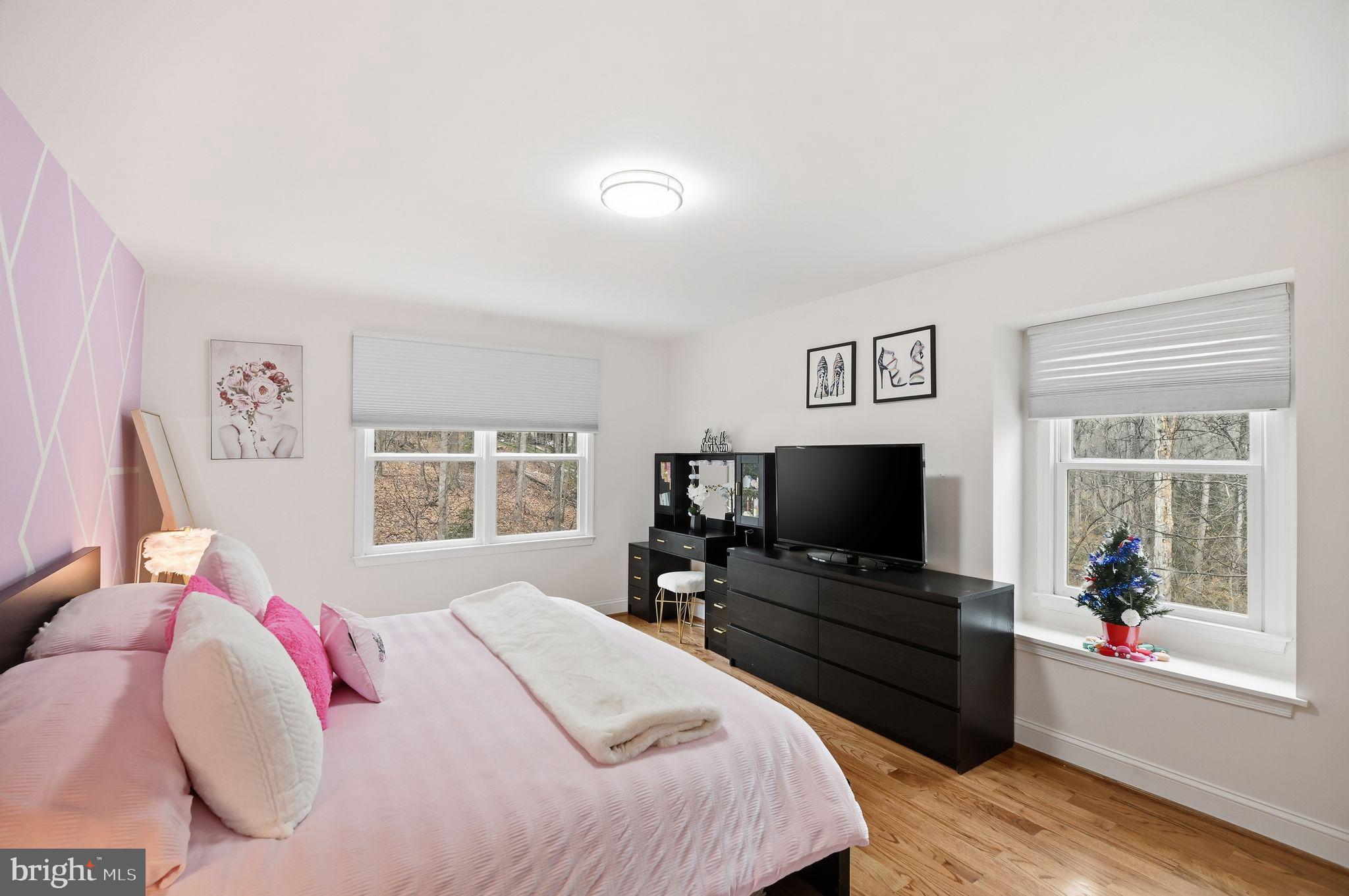 11728 Stuart Mill Road Oakton, VA 22124 - Photo 48 of 88 a bedroom with a bed and a flat screen tv