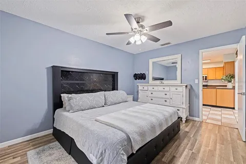 a bedroom with a large bed and a chandelier