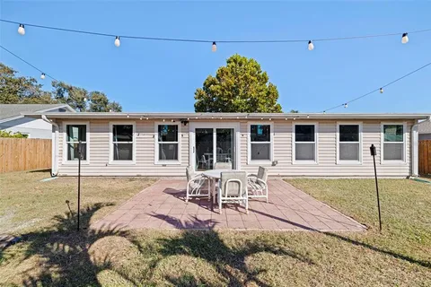 a front view of house with yard patio and glass windows