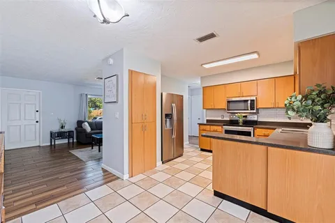 a kitchen with stainless steel appliances a refrigerator and a stove