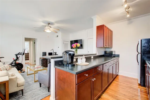 a kitchen with stainless steel appliances granite countertop a sink a stove and a refrigerator