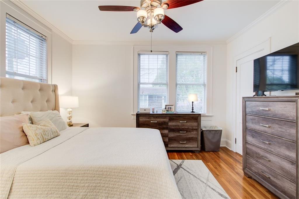 733 Frederica Street Northeast, Unit 12 Atlanta, GA 30306 - Photo 18 of 23 a bedroom with a bed and a flat screen tv