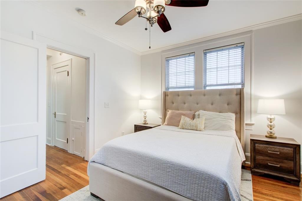 733 Frederica Street Northeast, Unit 12 Atlanta, GA 30306 - Photo 21 of 23 a bedroom with a bed and wooden floor