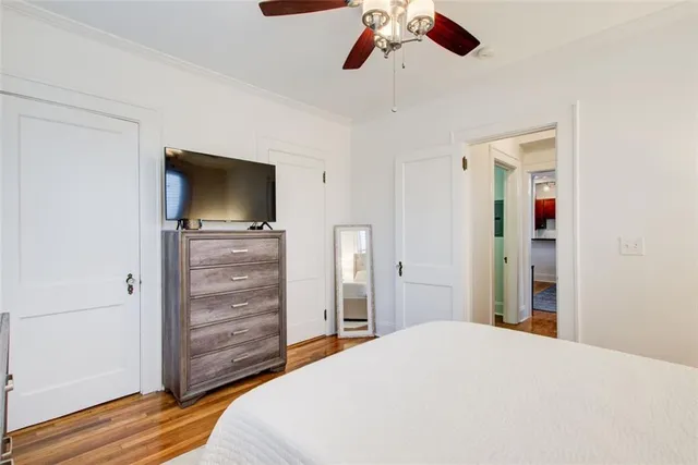 a bedroom with a bed and wooden floor