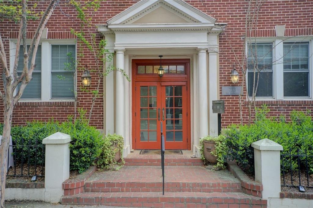 733 Frederica Street Northeast, Unit 12 Atlanta, GA 30306 - Photo 3 of 23 a front view of a house with a garden and plants