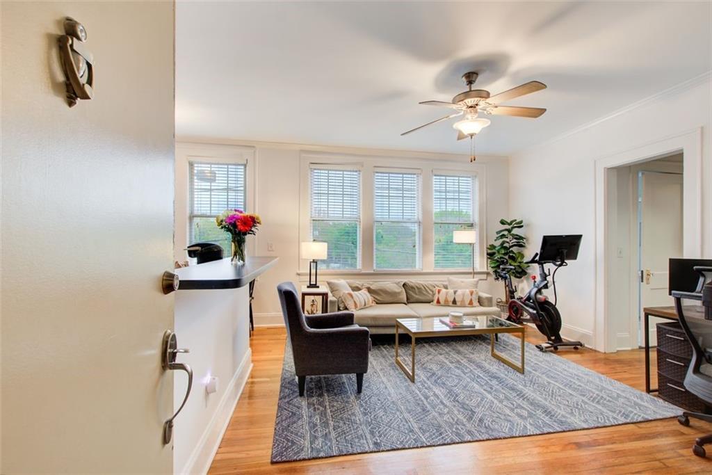 733 Frederica Street Northeast, Unit 12 Atlanta, GA 30306 - Photo 5 of 23 a living room with furniture gym equipment and a large window
