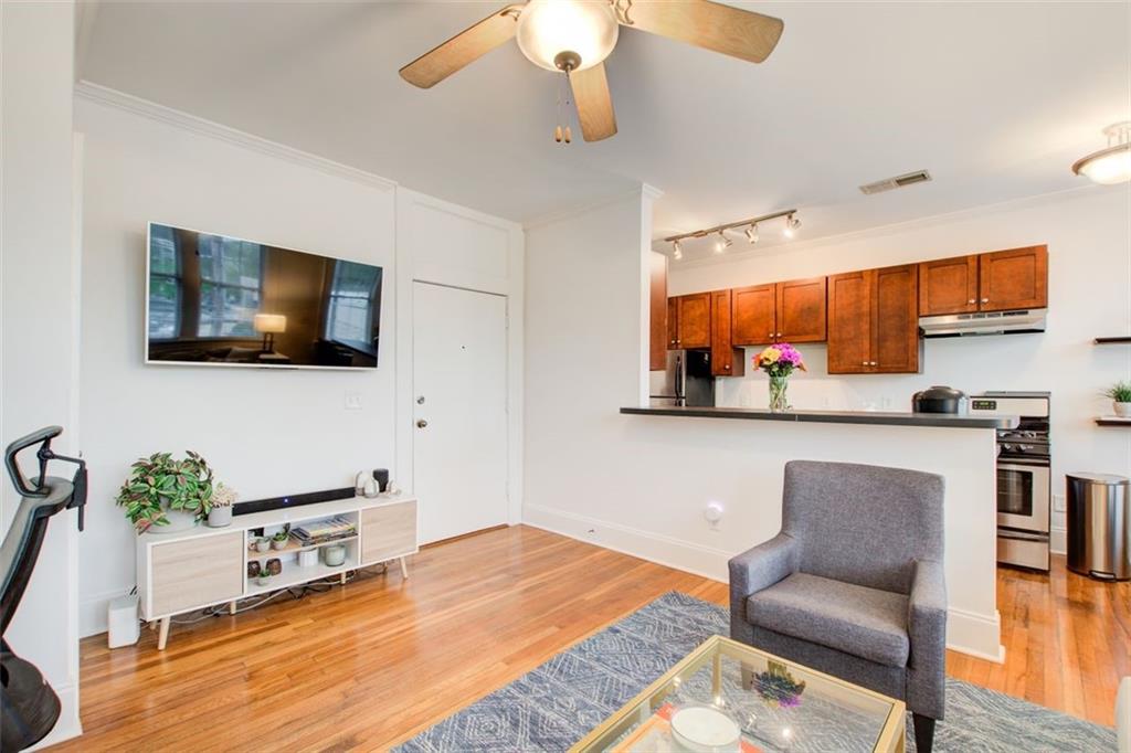 733 Frederica Street Northeast, Unit 12 Atlanta, GA 30306 - Photo 6 of 23 a living room with furniture and a flat screen tv