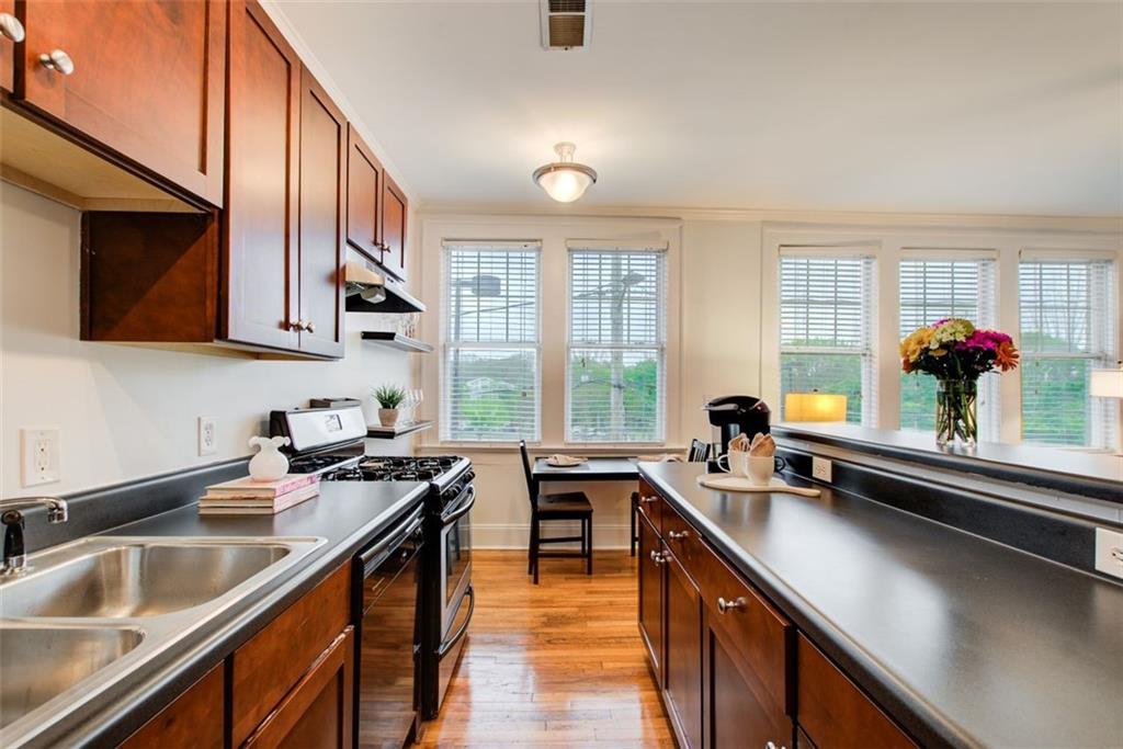 733 Frederica Street Northeast, Unit 12 Atlanta, GA 30306 - Photo 8 of 23 a kitchen with a sink a counter and cabinets