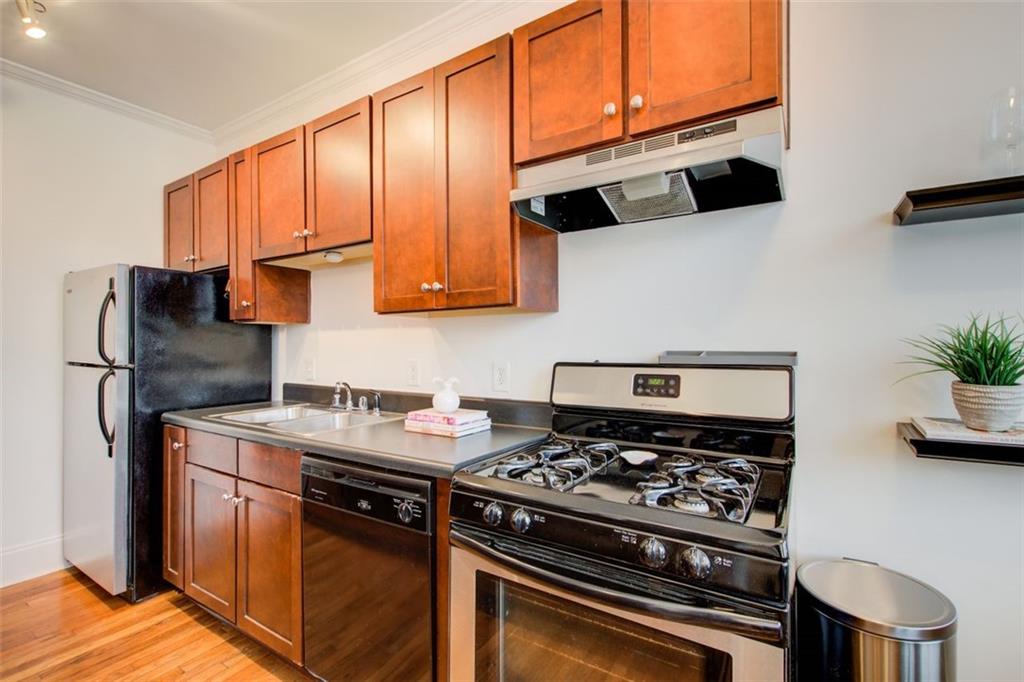 733 Frederica Street Northeast, Unit 12 Atlanta, GA 30306 - Photo 10 of 23 a kitchen with stainless steel appliances granite countertop a stove a sink and a microwave