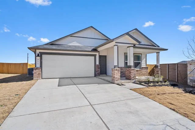 a front view of a house with yard