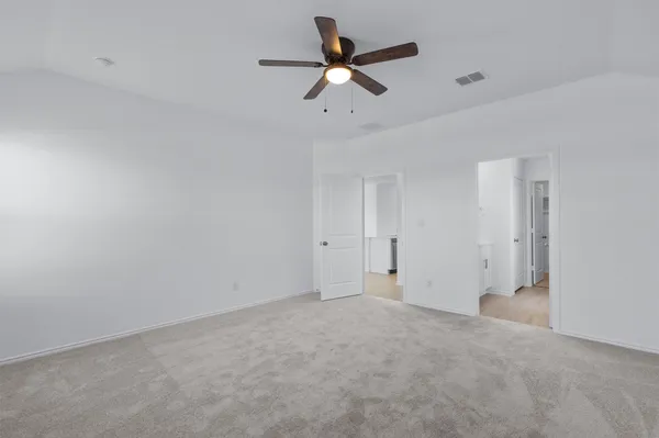 a view of a room with a ceiling fan and a window