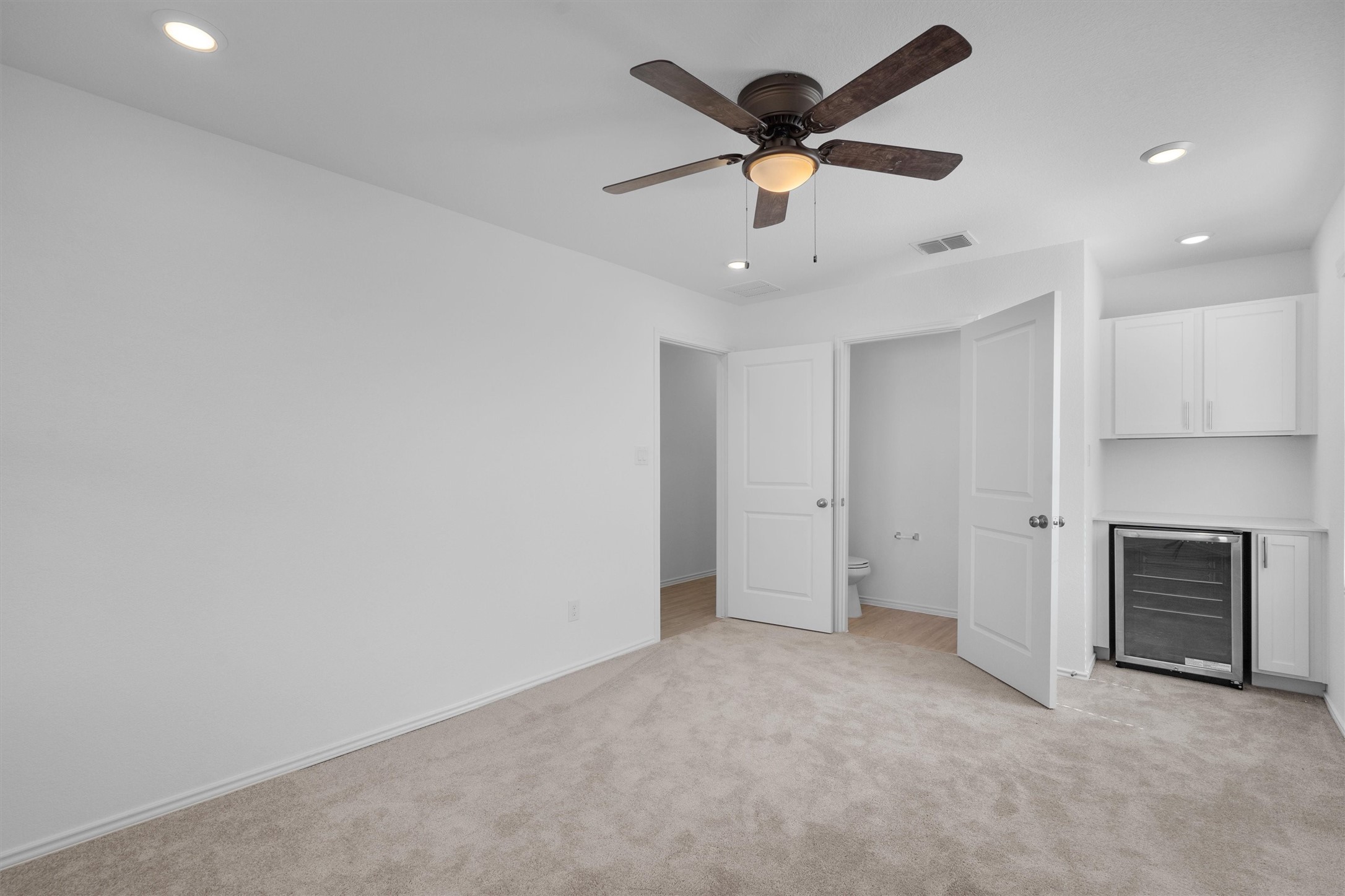 259 Sormonne Loop Kyle, TX 78640 - Photo 20 of 34 an empty room with a ceiling fan and a window