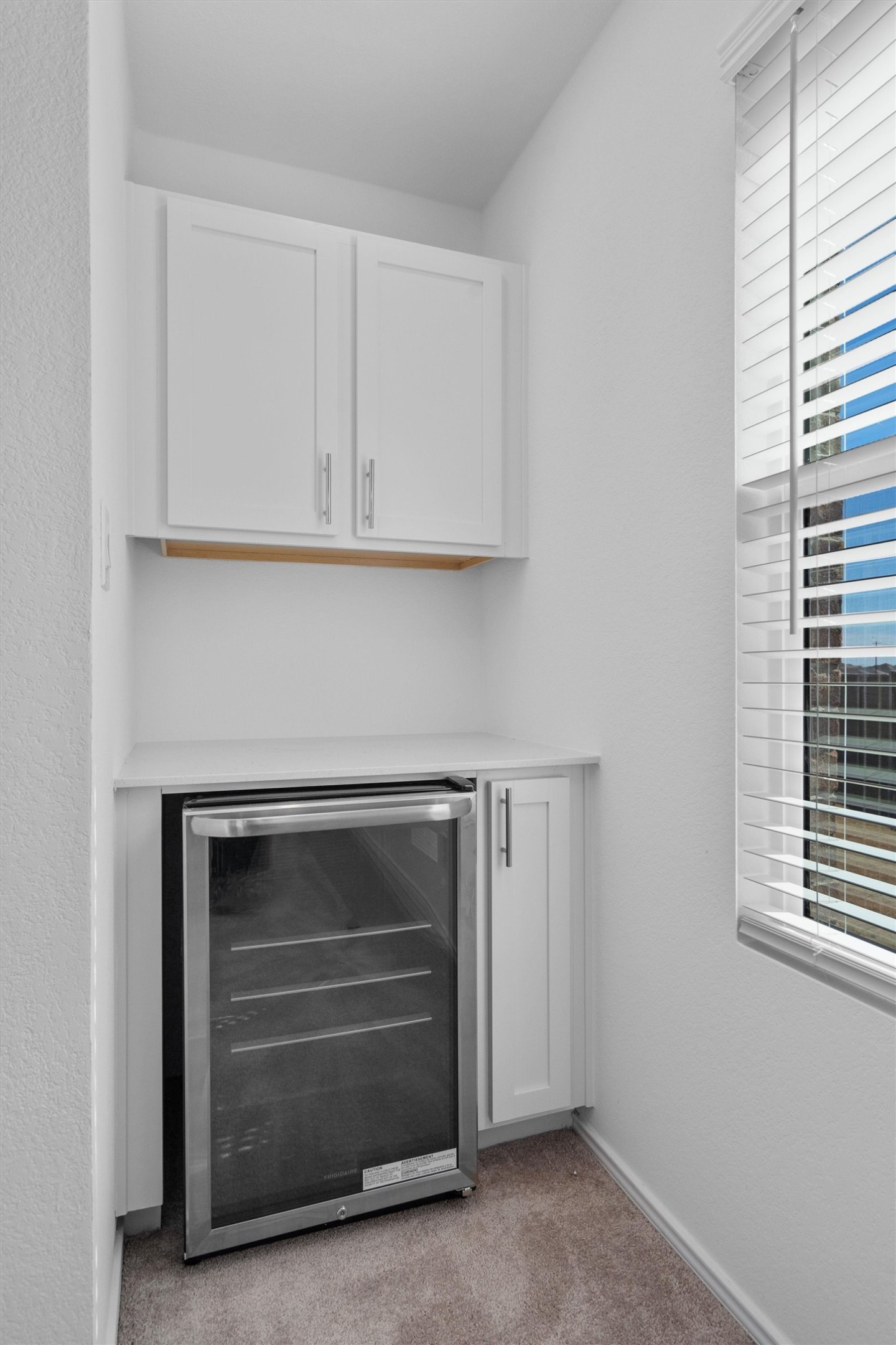 259 Sormonne Loop Kyle, TX 78640 - Photo 22 of 34 a kitchen with white cabinets and a fireplace