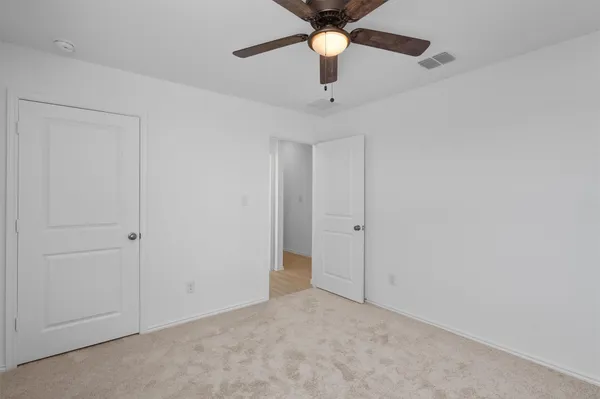 a view of a livingroom with a ceiling fan and window