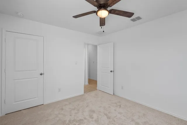a view of a livingroom with a ceiling fan and window