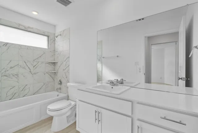 an empty room with a ceiling fan and a fan