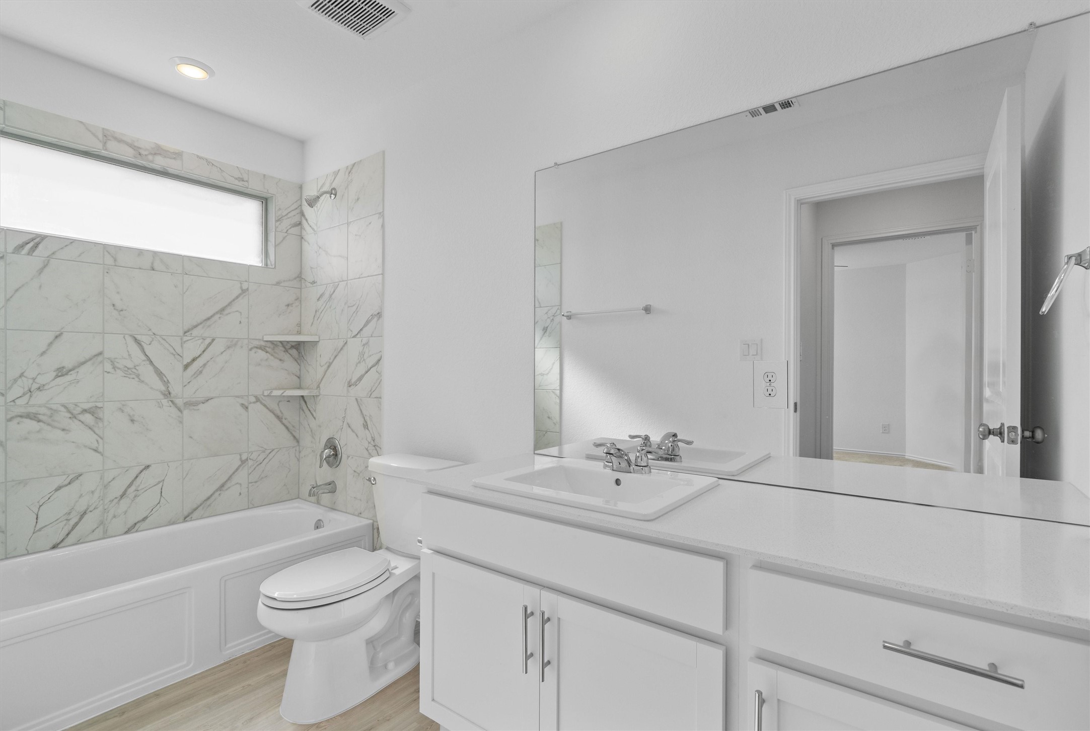259 Sormonne Loop Kyle, TX 78640 - Photo 25 of 34 a bathroom with a toilet a sink a mirror a bathtub and vanity