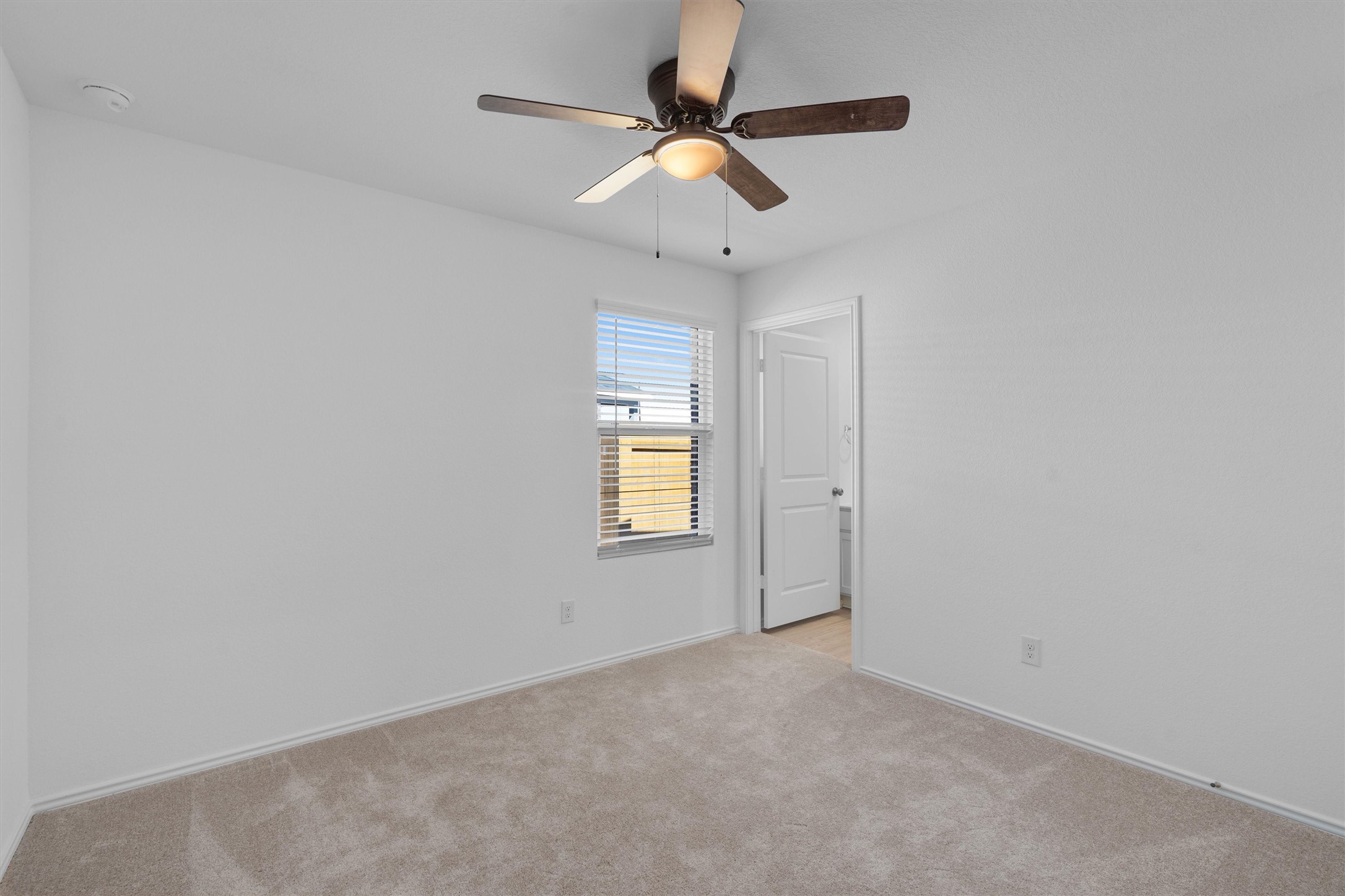 259 Sormonne Loop Kyle, TX 78640 - Photo 27 of 34 an empty room with ceiling fan and window