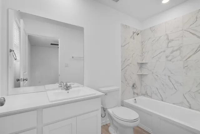 an empty room with closet and a chandelier fan