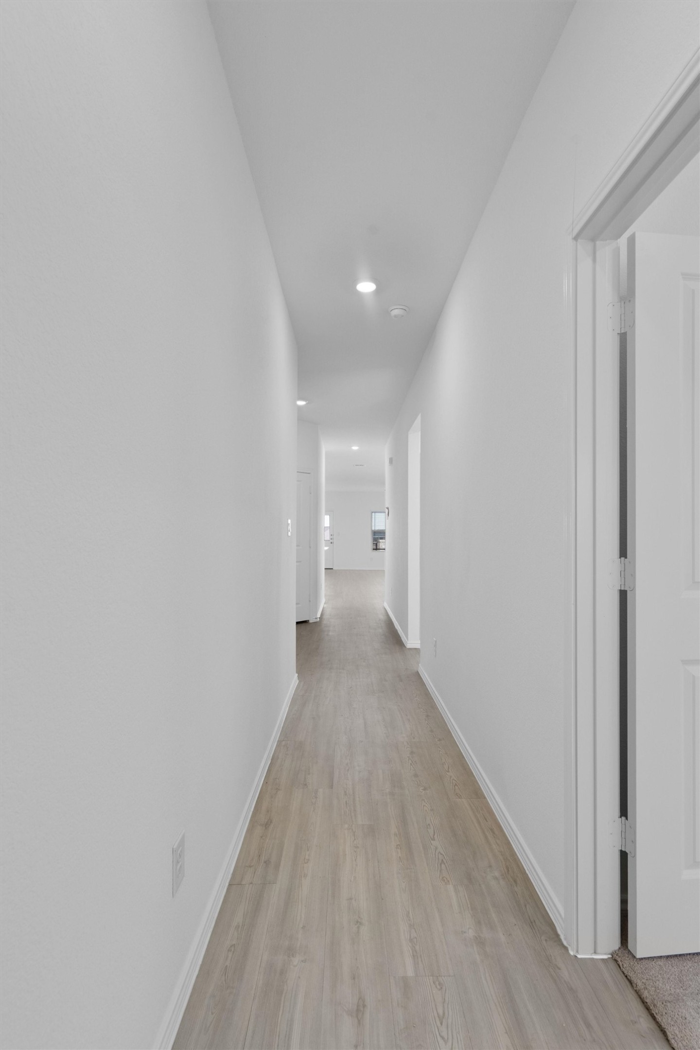 259 Sormonne Loop Kyle, TX 78640 - Photo 6 of 34 a view of a hallway with wooden floor