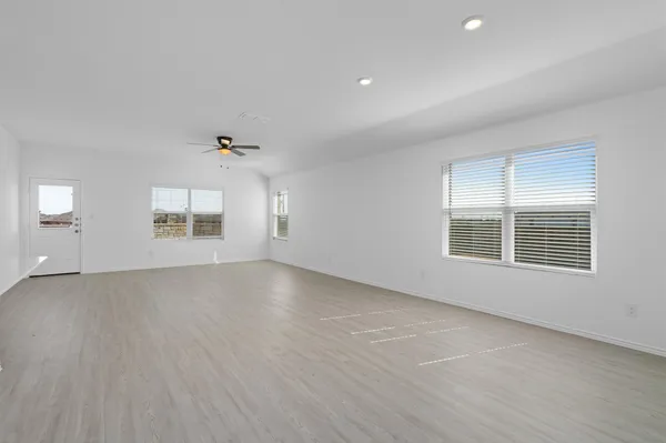 an empty room with windows and entrance