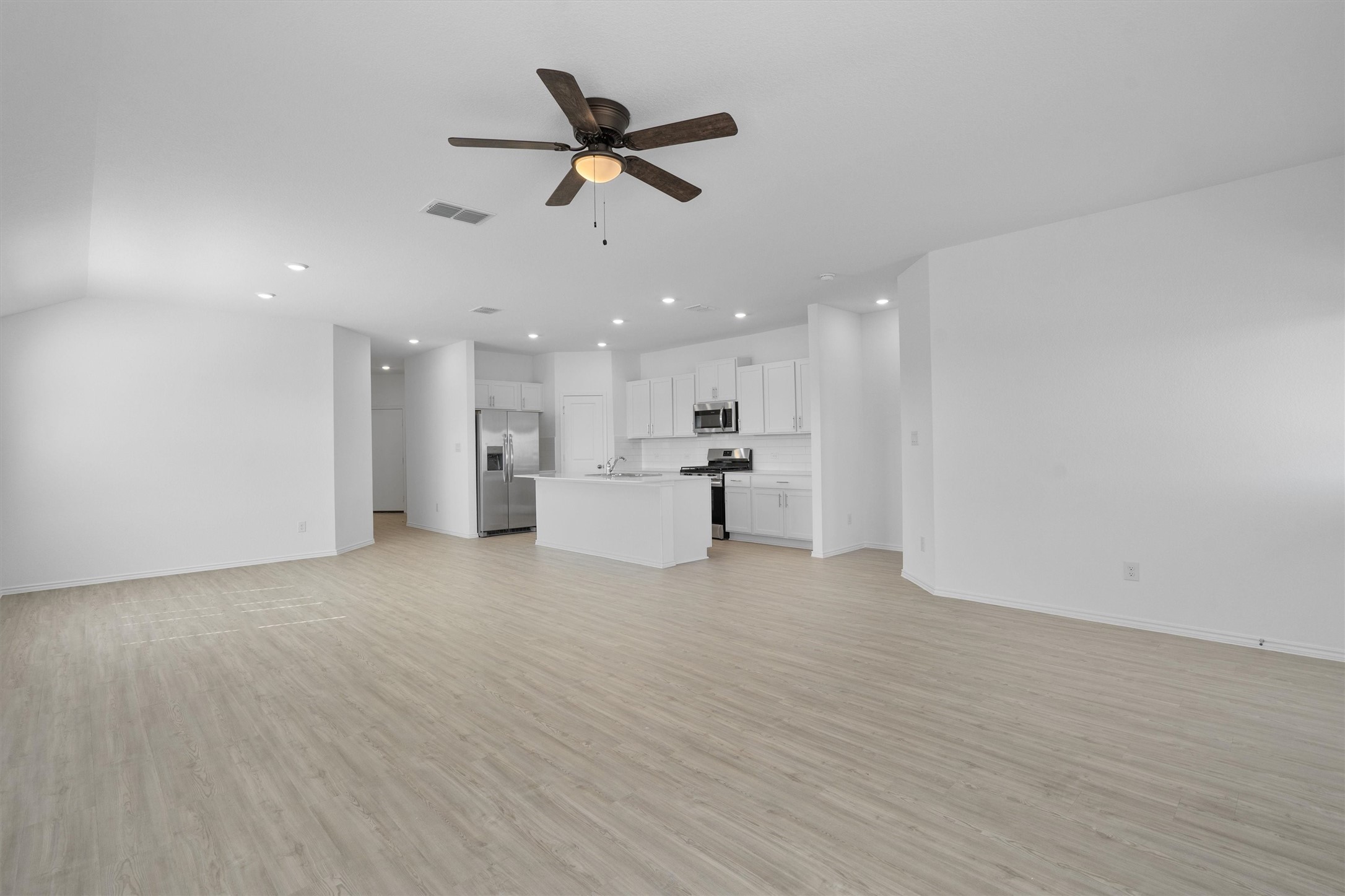 259 Sormonne Loop Kyle, TX 78640 - Photo 8 of 34 a view of a kitchen with a sink and a refrigerator