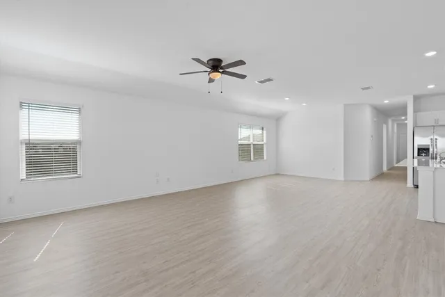 an empty room with a empty space and windows