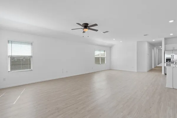 an empty room with a empty space and windows