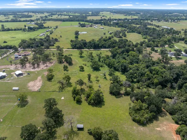 an aerial view of residential houses with outdoor space and river