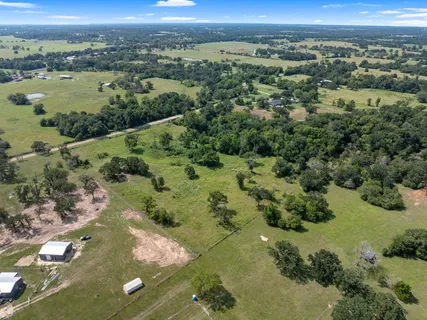 an aerial view of a houses with a yard