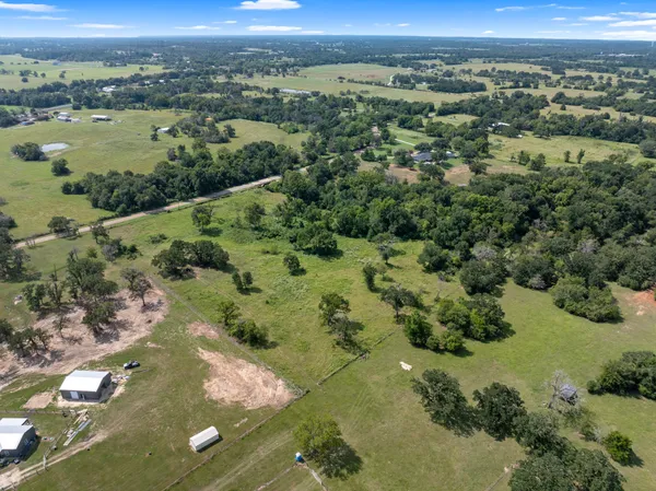 an aerial view of a houses with a yard