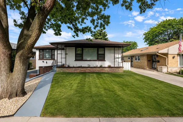 a view of a house with pool and a yard