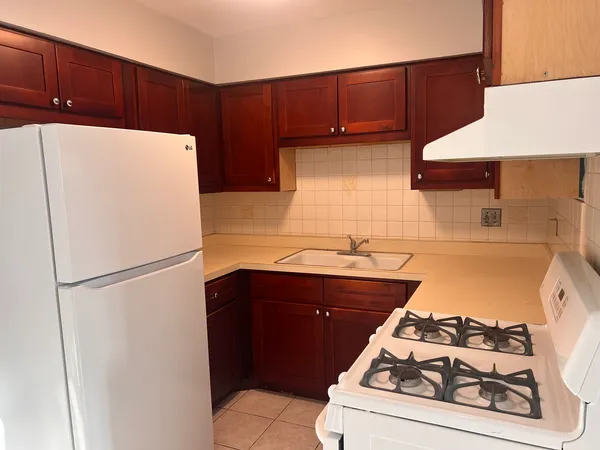 a kitchen with a refrigerator and a stove