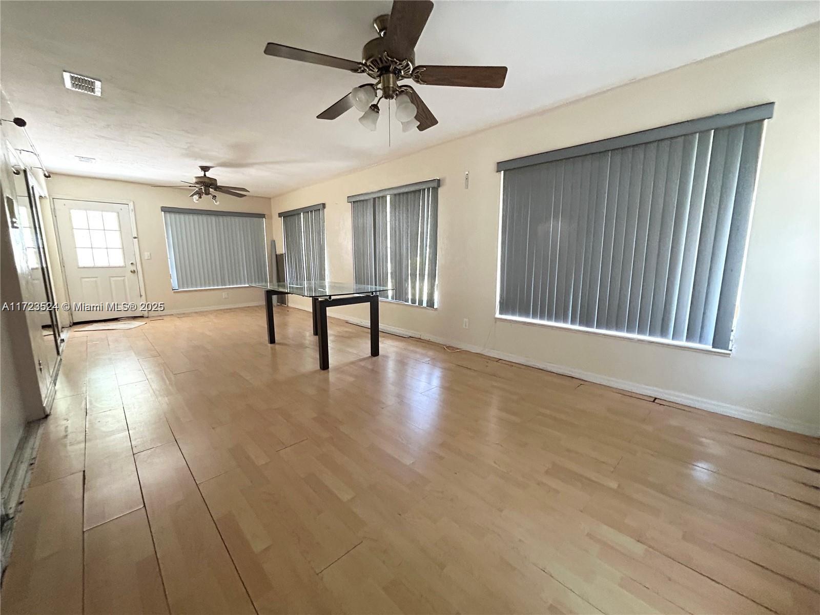 9227 Highway 80 Moore Haven, FL 33471 - Photo 13 of 20 a view of an empty room with window and wooden floor