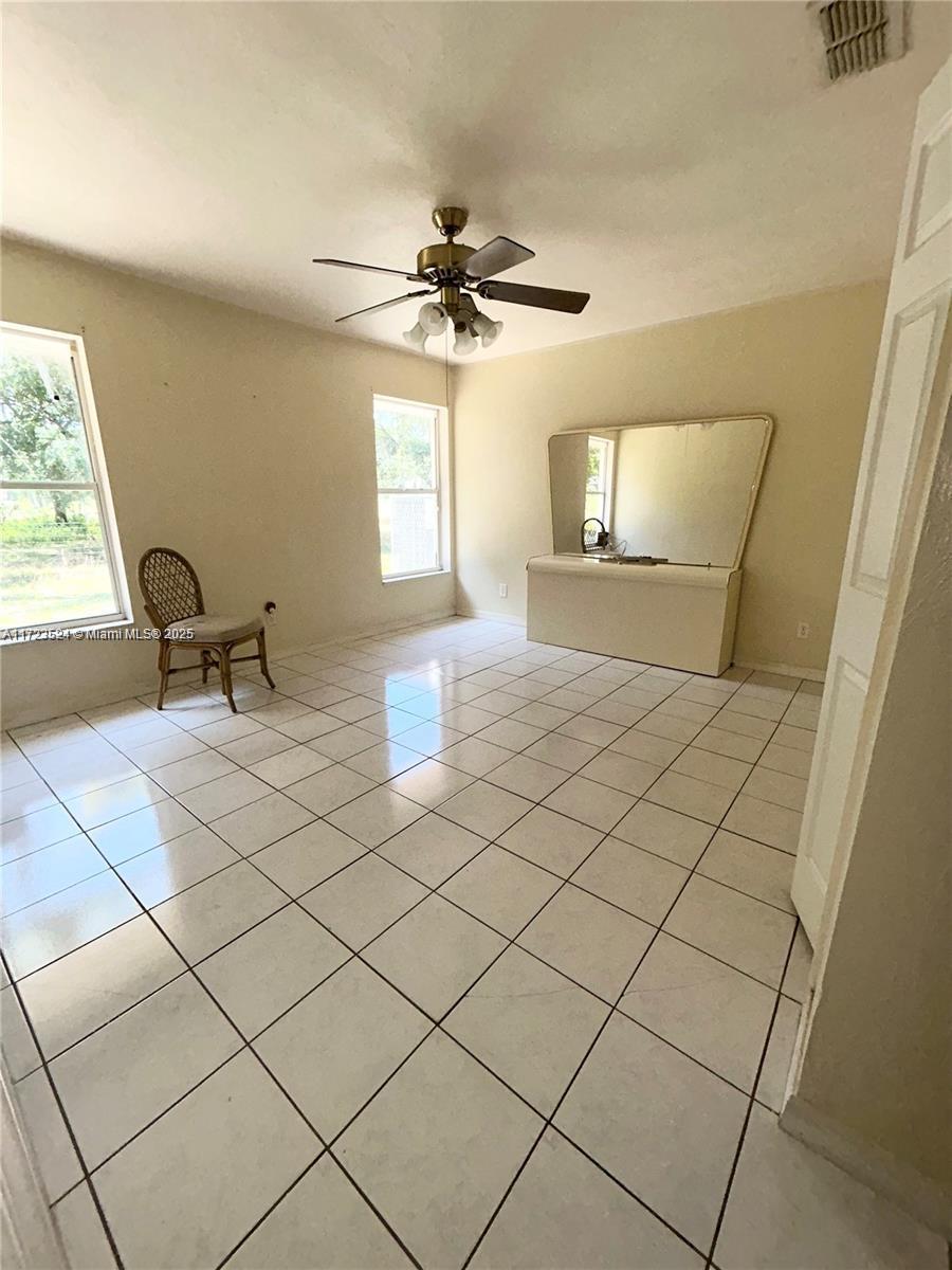 9227 Highway 80 Moore Haven, FL 33471 - Photo 19 of 20 a bedroom with a bed and a window