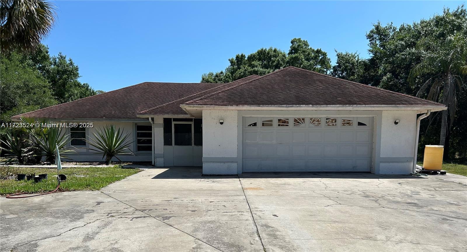 9227 Highway 80 Moore Haven, FL 33471 - Photo 3 of 20 a house with a yard
