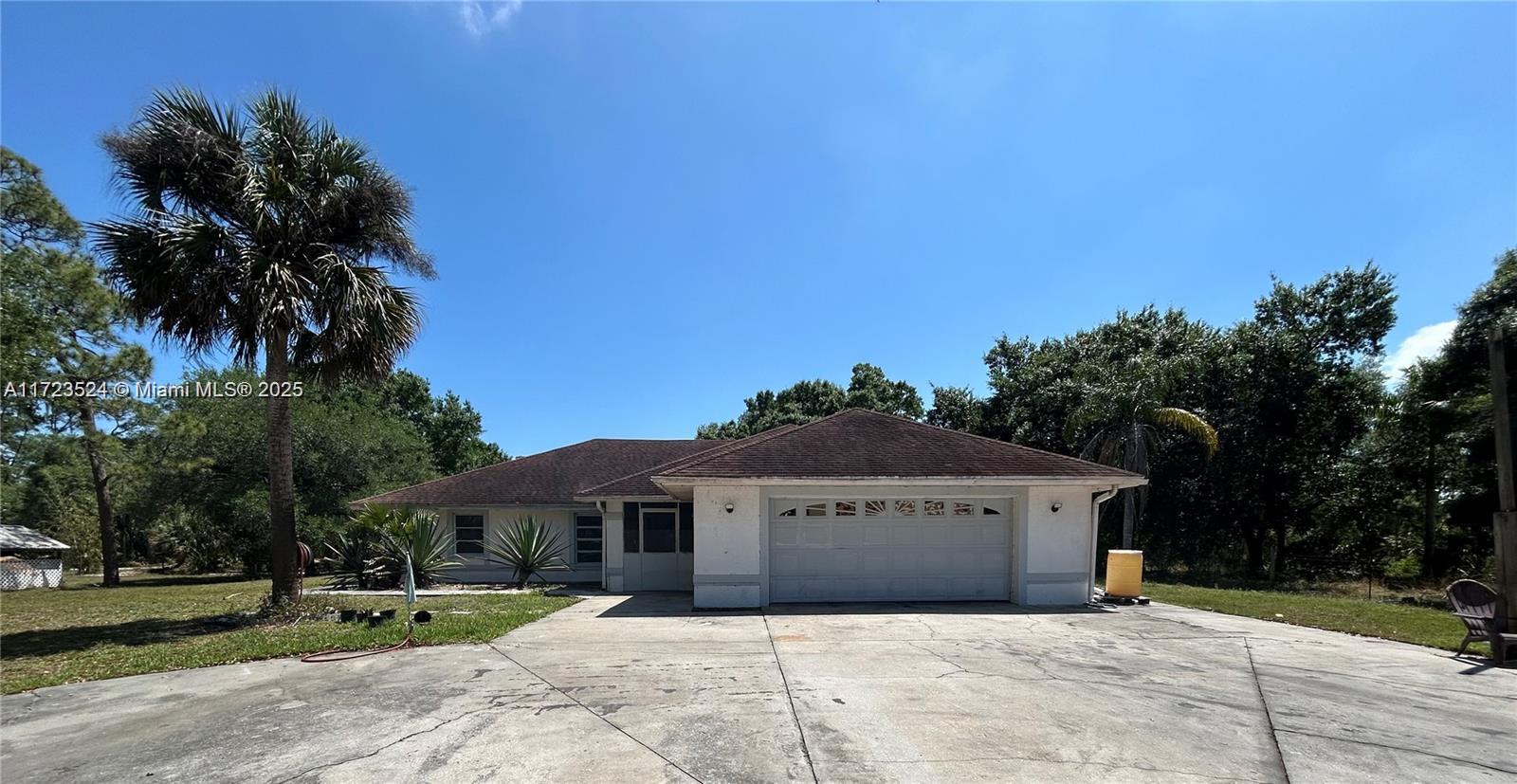 9227 Highway 80 Moore Haven, FL 33471 - Photo 4 of 20 a view of house with a yard and potted plants in front of house