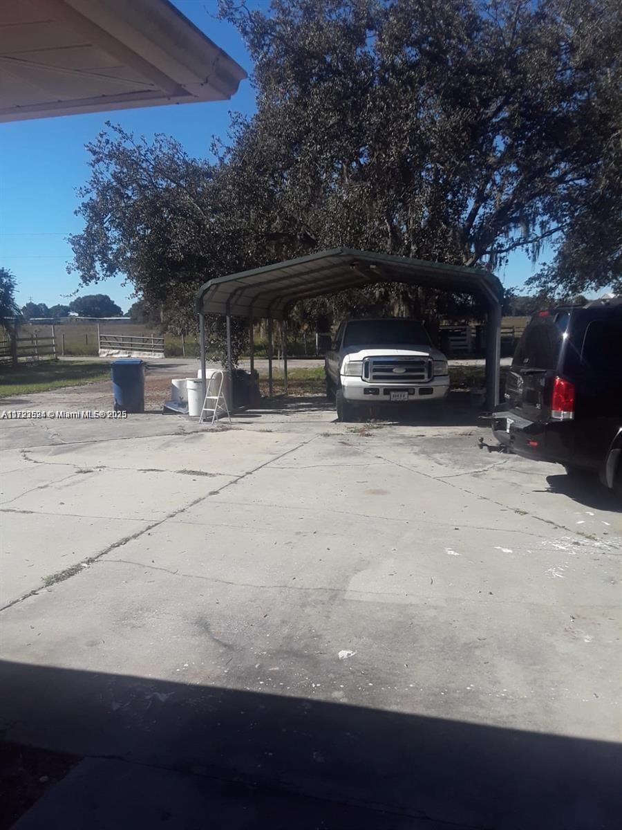 9227 Highway 80 Moore Haven, FL 33471 - Photo 7 of 20 a view of backyard with parked car and city view
