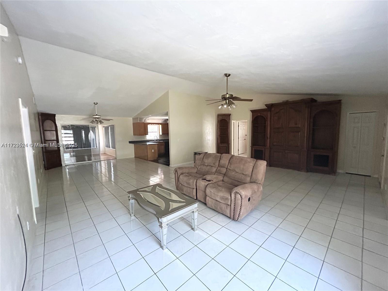 9227 Highway 80 Moore Haven, FL 33471 - Photo 10 of 20 a living room with furniture and a chandelier
