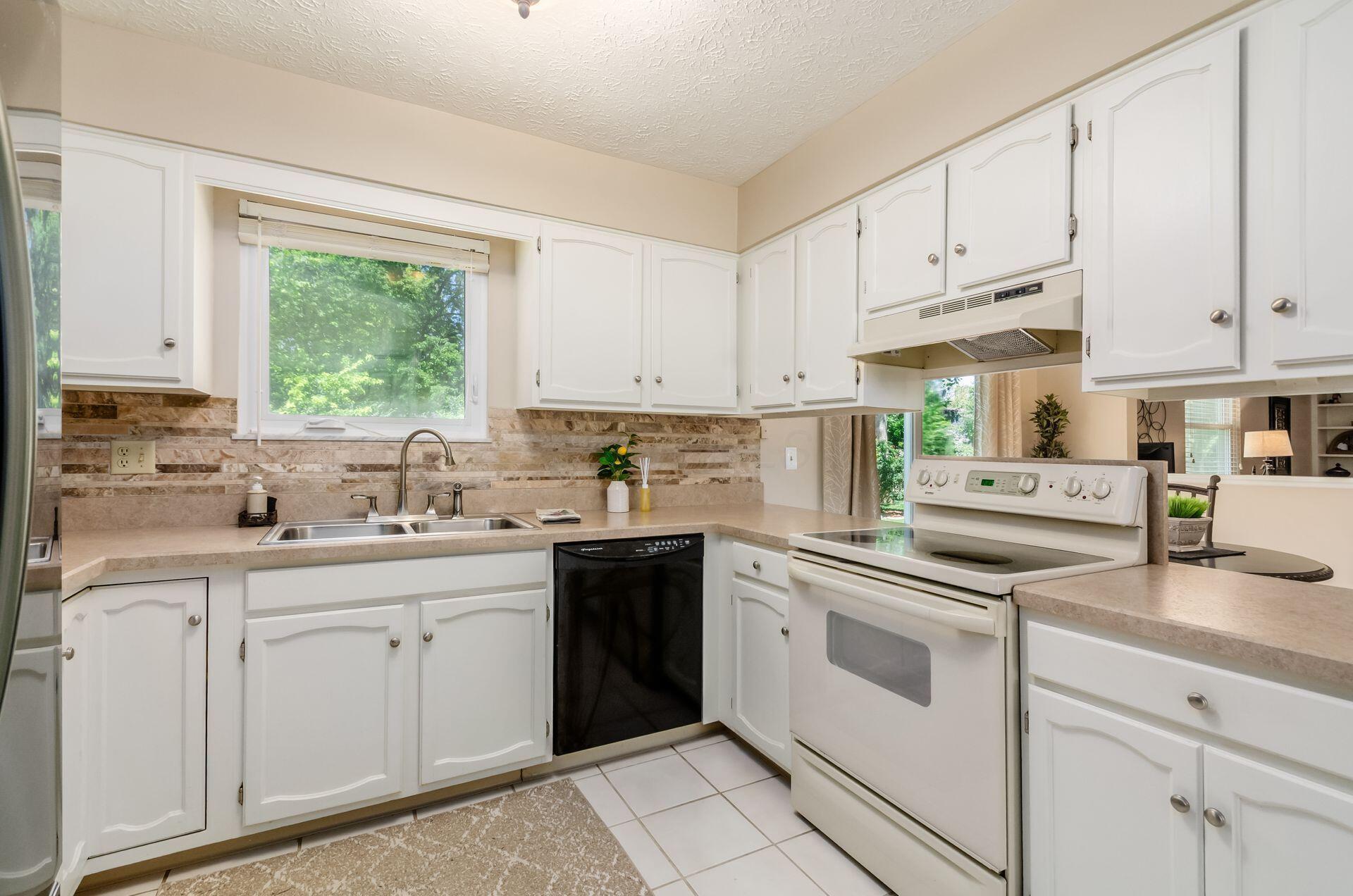 7771 Strathmoore Road Dublin, OH 43016 - Photo 16 of 32 Kitchen with Electric Range w/Hood, Dishwasher & Refrigerator.