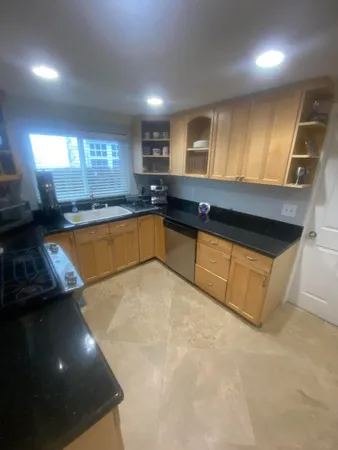 a kitchen with stainless steel appliances granite countertop a sink and cabinets