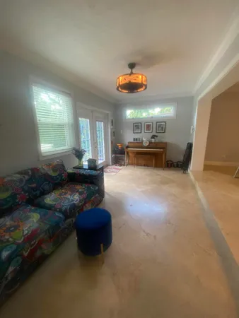 a living room with furniture and a dining table