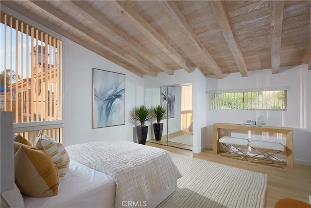 a bedroom with a bed and a large window