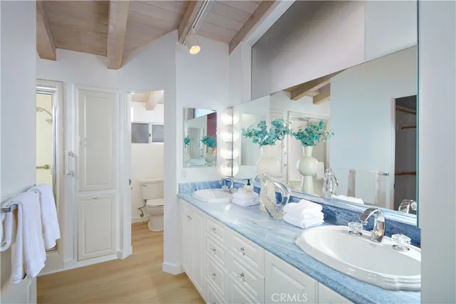 a bathroom with a granite countertop sink mirror and vanity