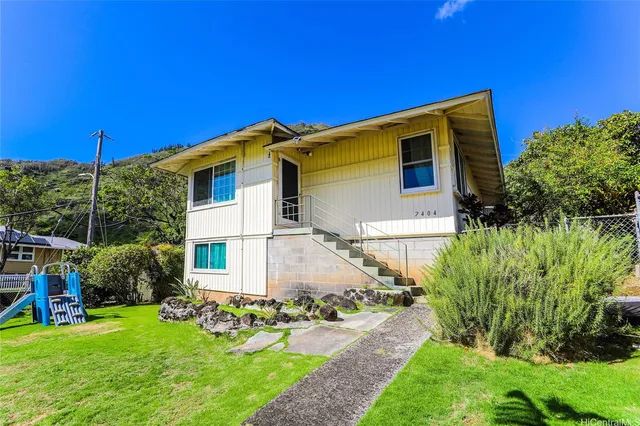 a front view of a house with garden